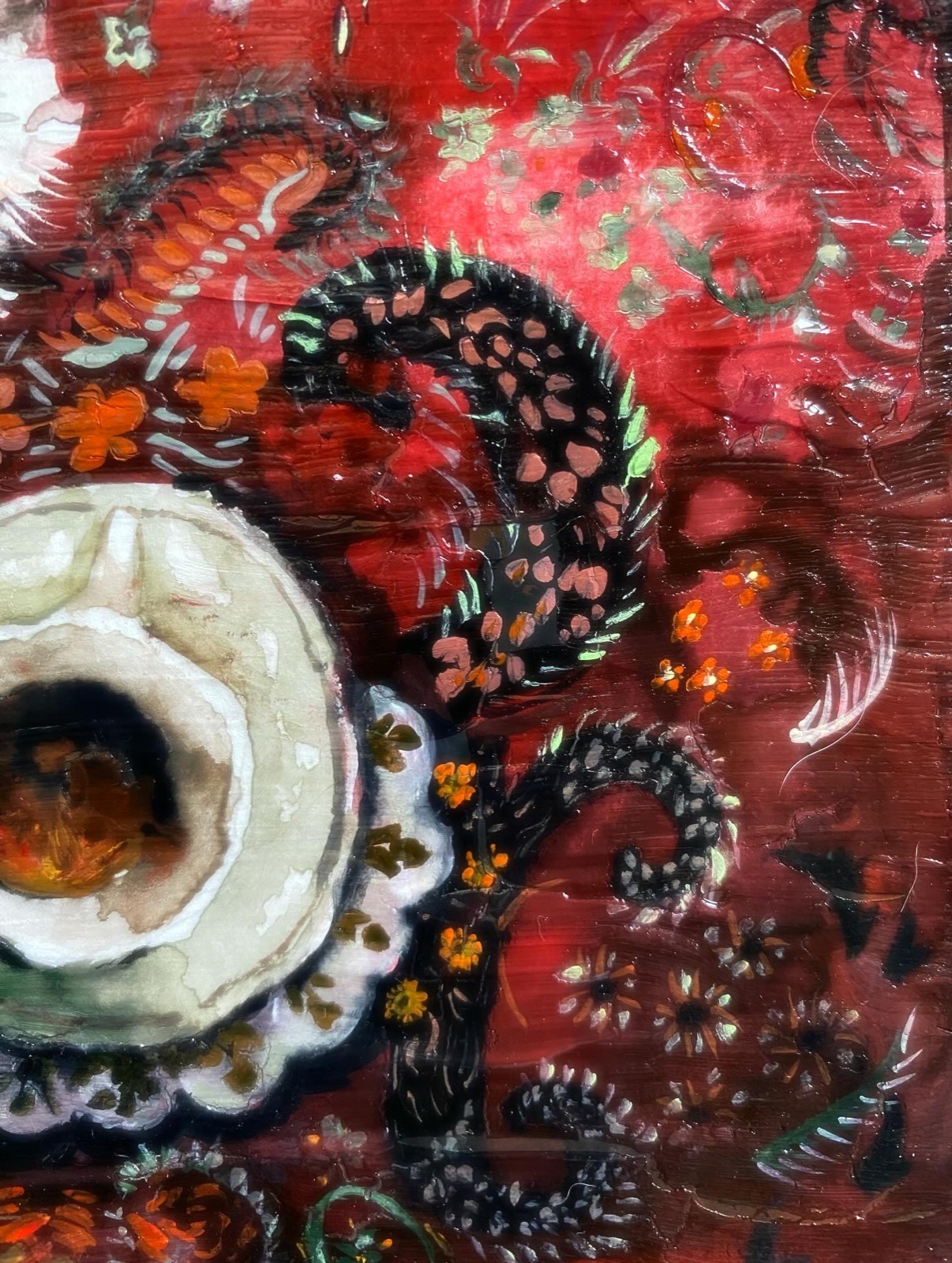Textured painting in deep reds with ceramics
