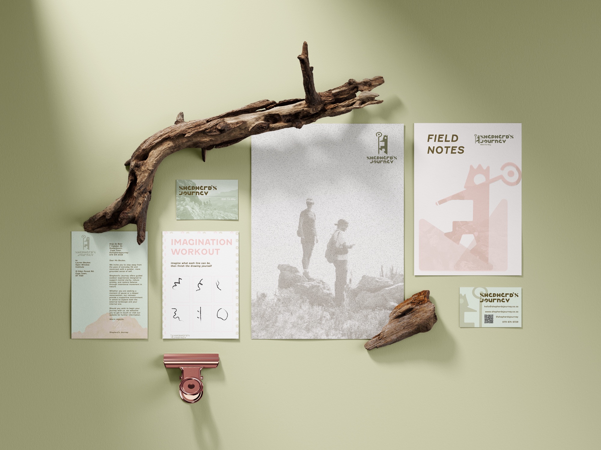 Shepherd’s Journey stationery suite — brochures, field notes and badges on a sage wall