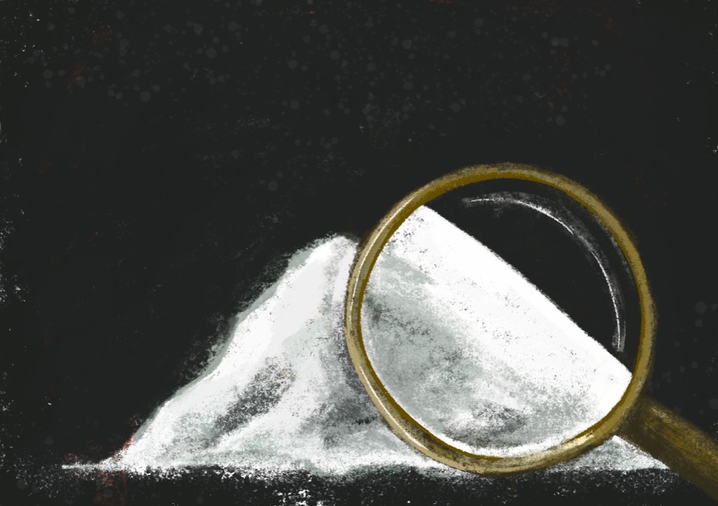 A pile of white salt examined under a brass magnifying glass, on a black ground